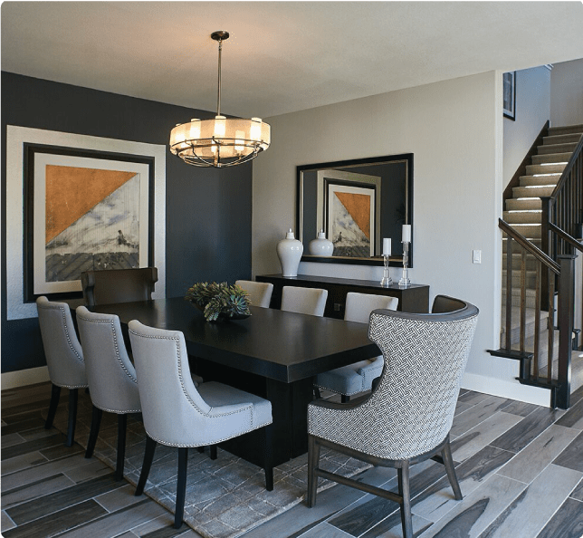 A dining room with a dark wood table and gray chairs