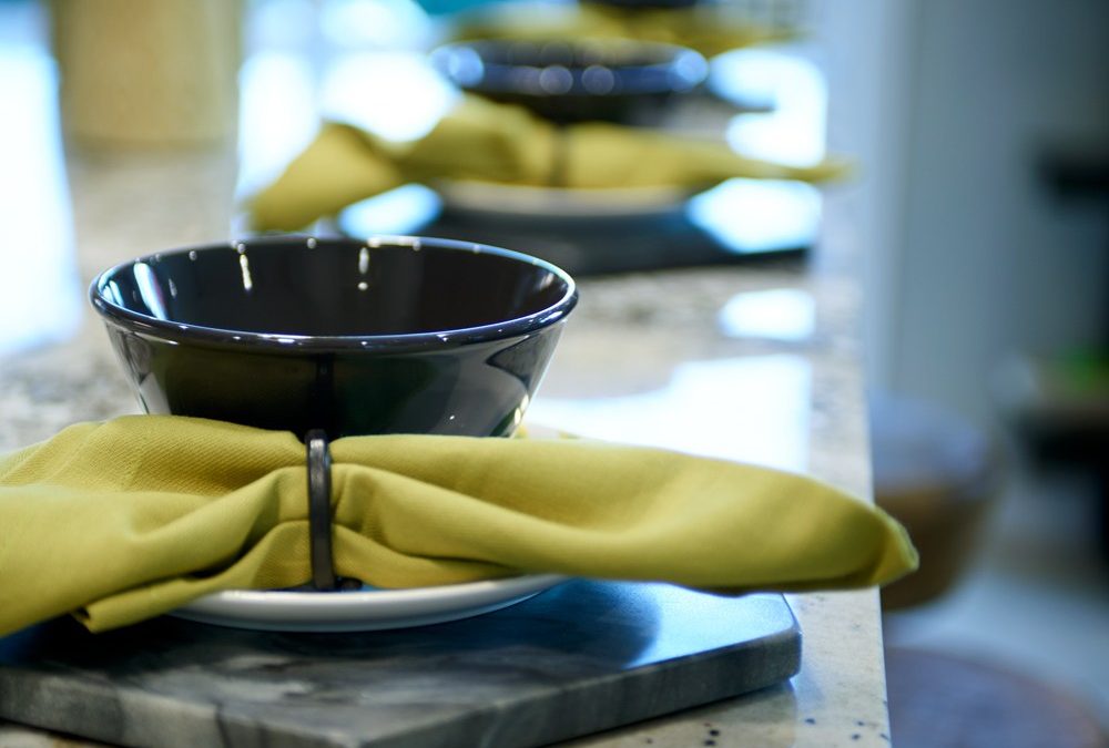 close-up place setting, lime green napkin and black bowl