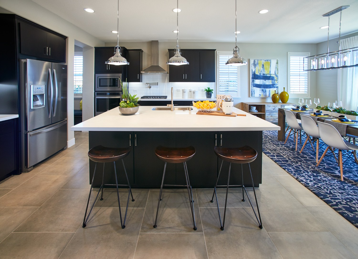 An open concept kitchen with dark cabinetry