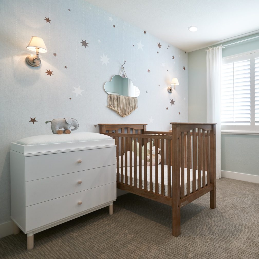 A crib and changing table in a nursery
