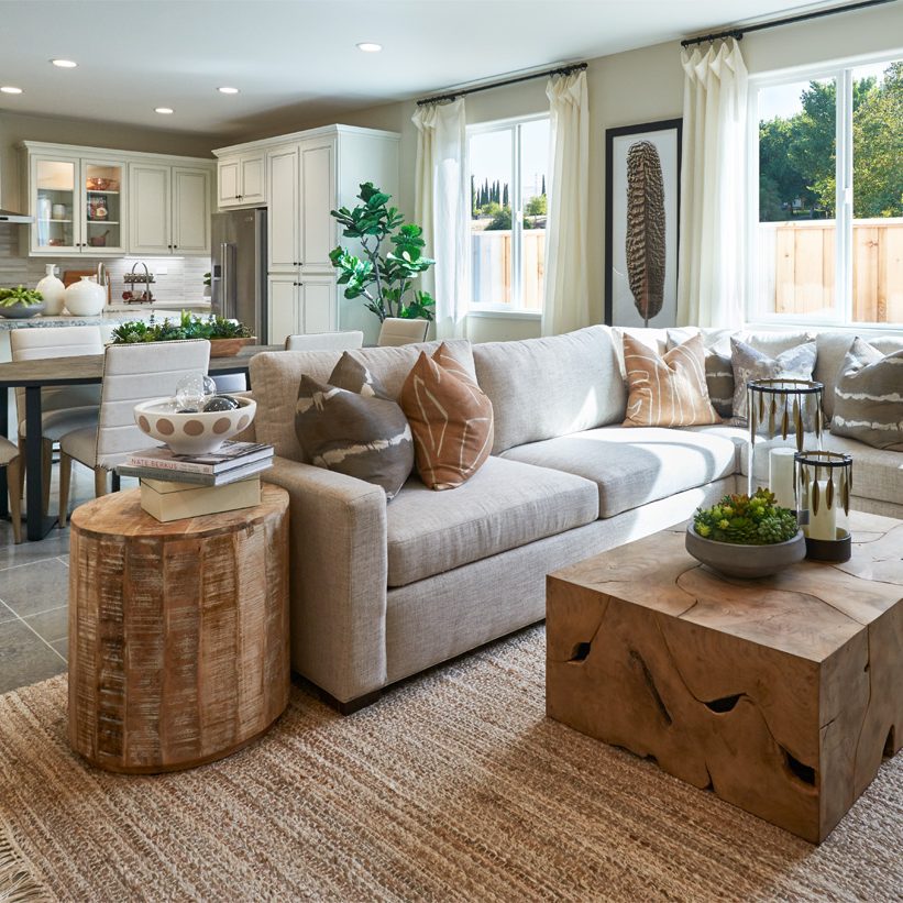 An open concept great room and kitchen with a grey sectional